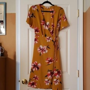 Mustard colored wrap dress with flower pattern